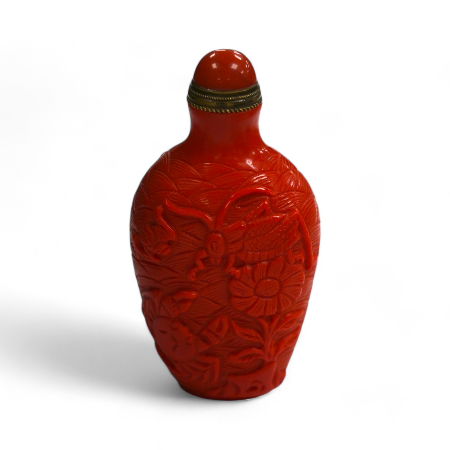 A Chinese coral coloured glass 'crabs' snuff bottle, 8.2cm high. Condition - good